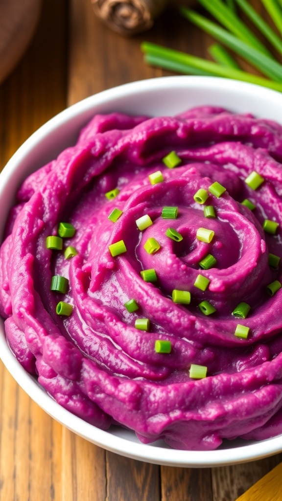 Creamy mashed Okinawan sweet potatoes in a bowl, garnished with chives, on a rustic wooden table.